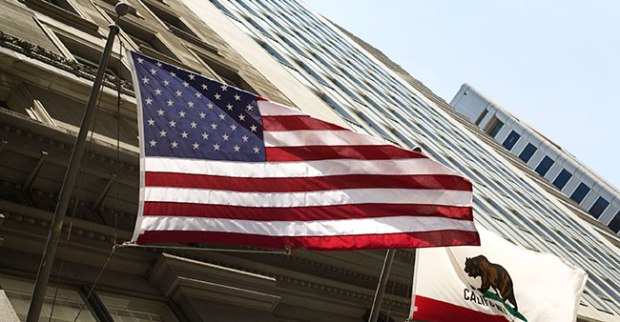 american flag flying from a building