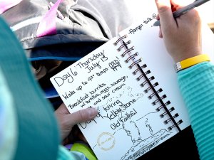 Scout writing in a journal