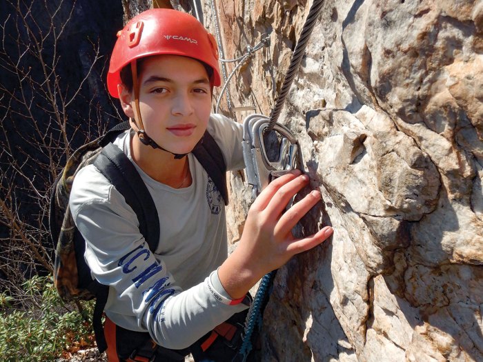 A Scout climbs the iron way route at NROCKS